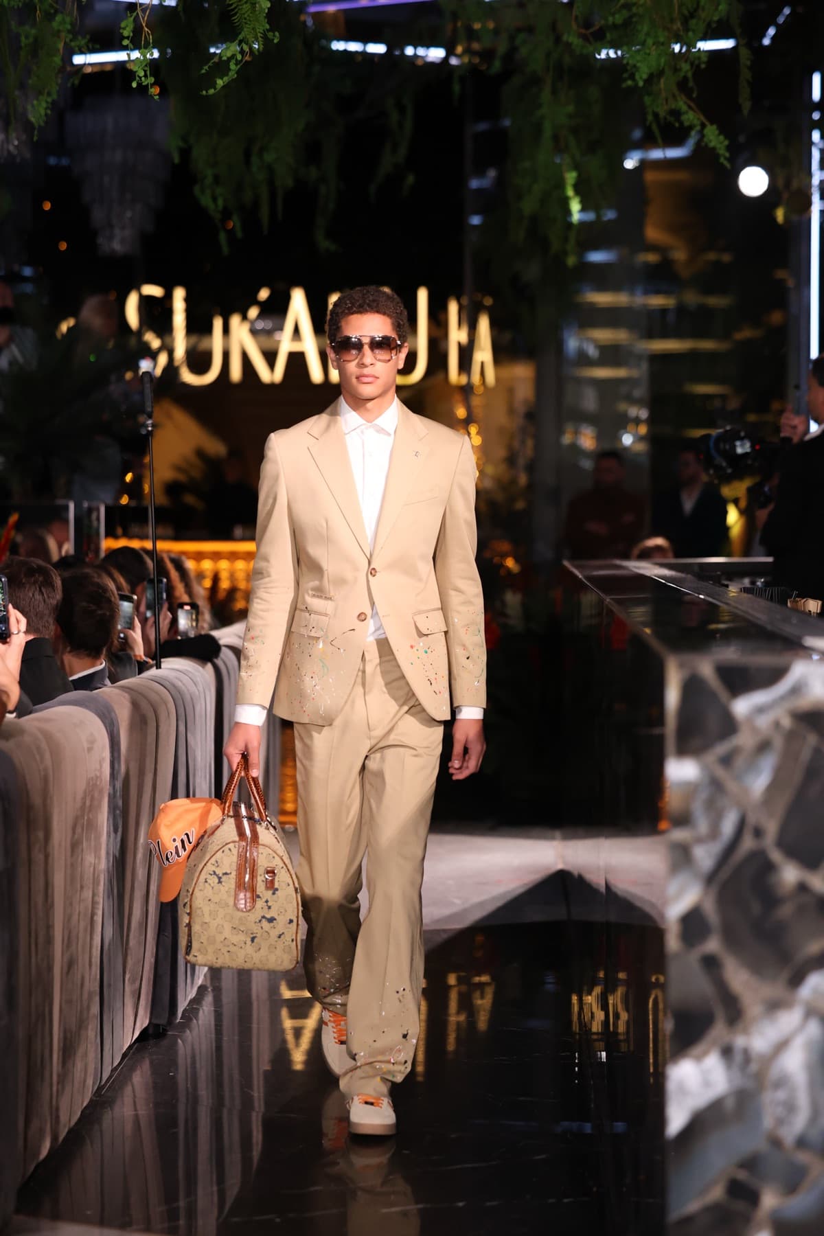 Beige menswear suit with hand painted detailing and aviator sunglasses