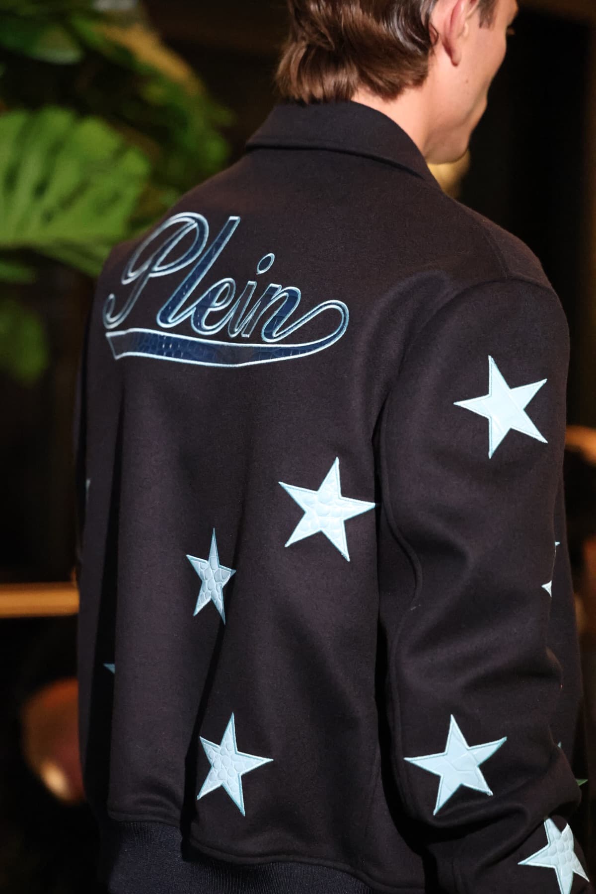 The back of a varsity jacket with the Plein script and stars