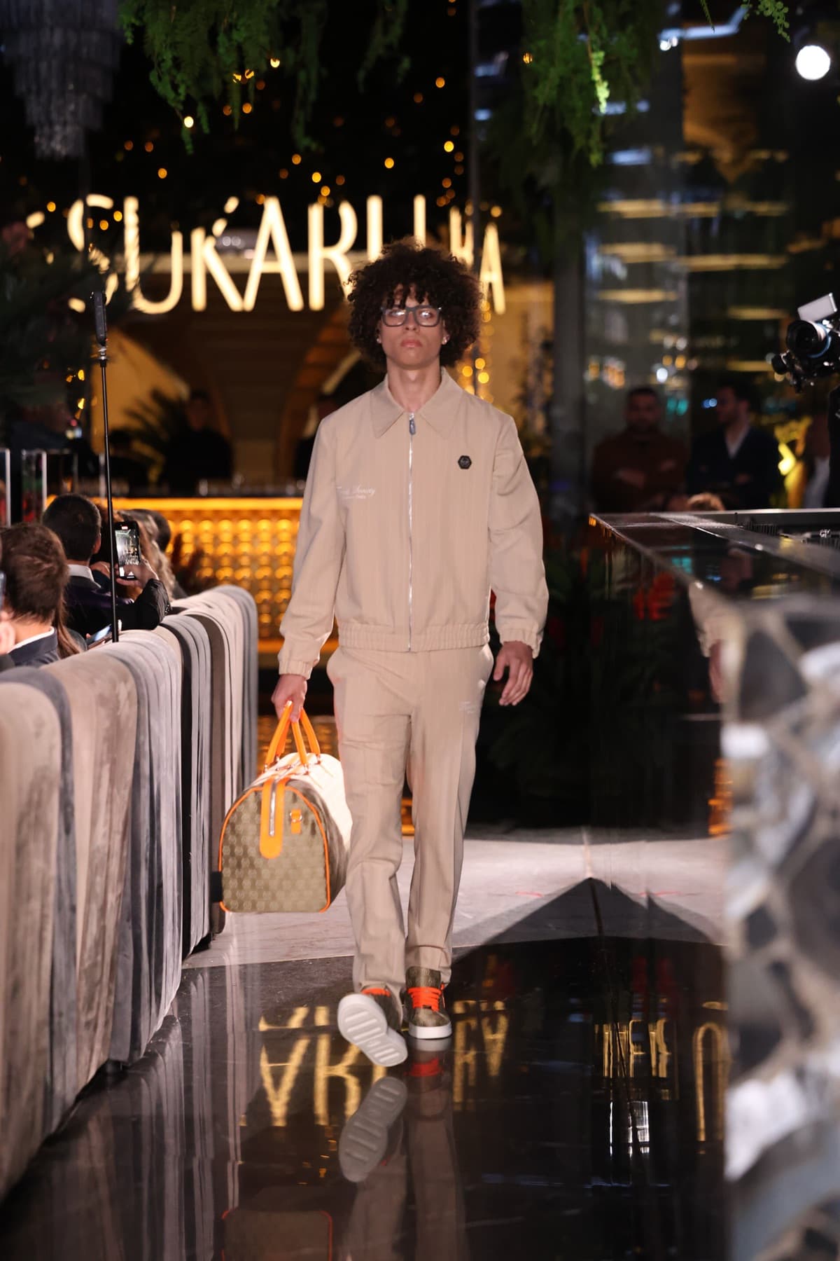 Tailoring worn with a logo cap