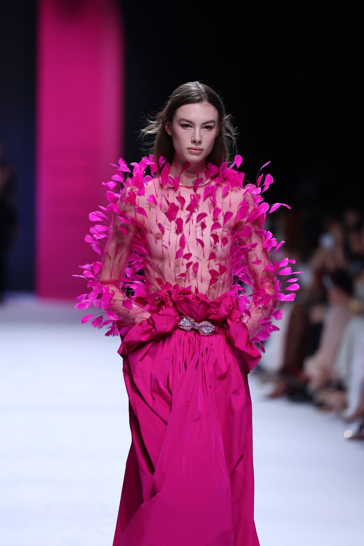 Feathered blush top over a fuchsia skirt on the Milan runway, February 2026